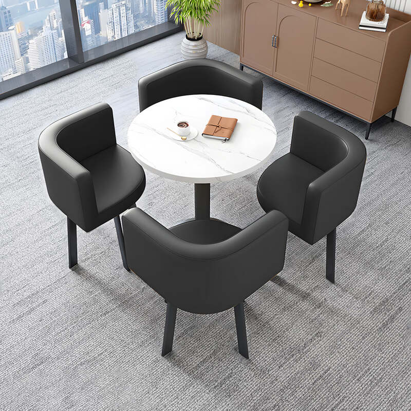 Round dining table with four black upholstered chairs